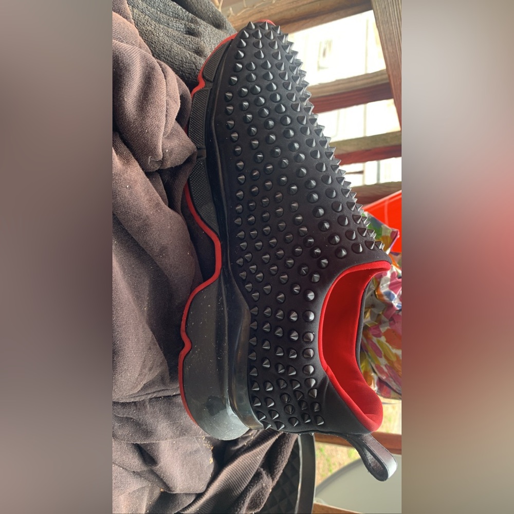 All black Christian Louboutin spike sneakers